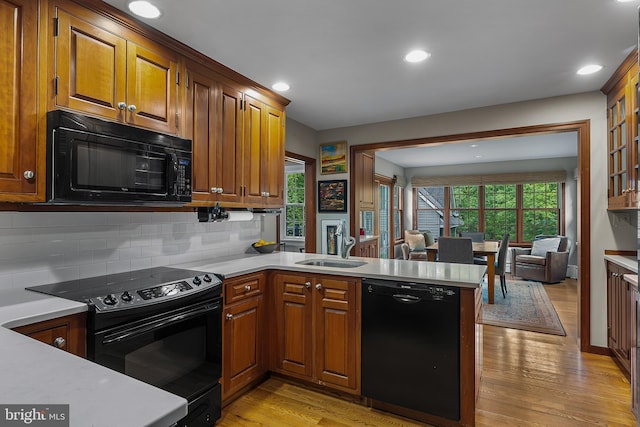 410 Heatherwood Ln, Devon, PA 19333 - kitchen with black appliances, a sink, light countertops, a peninsula, and recessed lighting