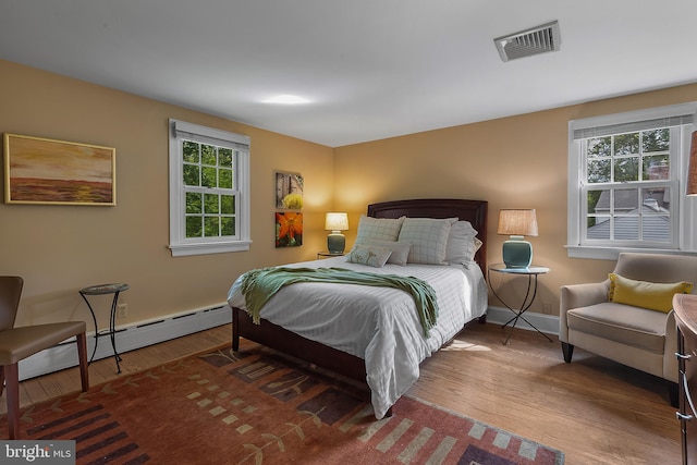 410 Heatherwood Ln, Devon, PA 19333 - bedroom with wood finished floors, baseboards, and baseboard heating