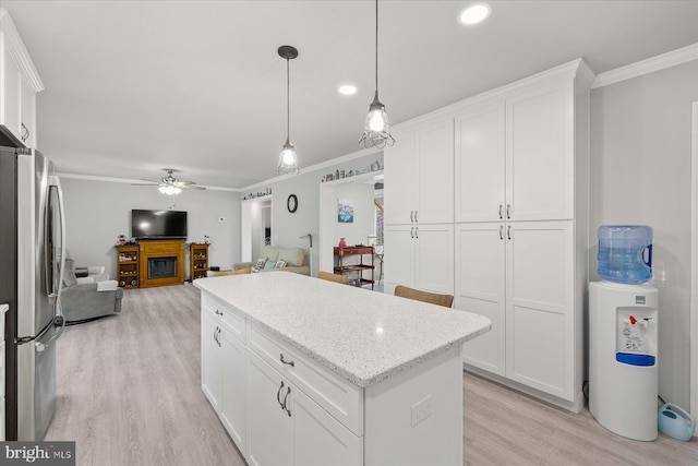 36032 Double Bridges Rd, Frankford, DE 19945 - kitchen featuring freestanding refrigerator, crown molding, light wood-style floors, ceiling fan, and white cabinetry