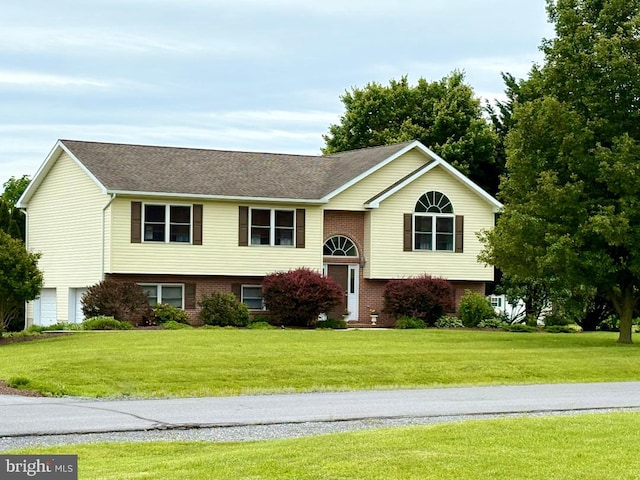 362 Sudley Ln, Martinsburg, WV 25403 - raised ranch with brick siding, a front yard, a shingled roof, and an attached garage