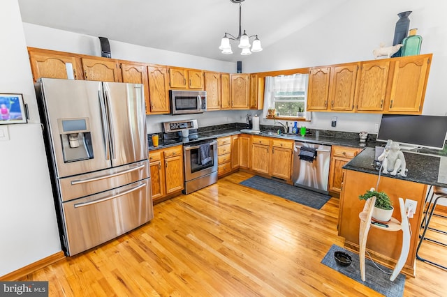 362 Sudley Ln, Martinsburg, WV 25403 - kitchen with appliances with stainless steel finishes, a sink, light wood finished floors, pendant lighting, and vaulted ceiling
