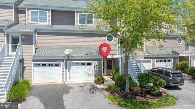 38178 Dockside Dr Unit 1266, Selbyville, DE 19975 - townhome / multi-family property featuring an attached garage, driveway, stairway, and roof with shingles