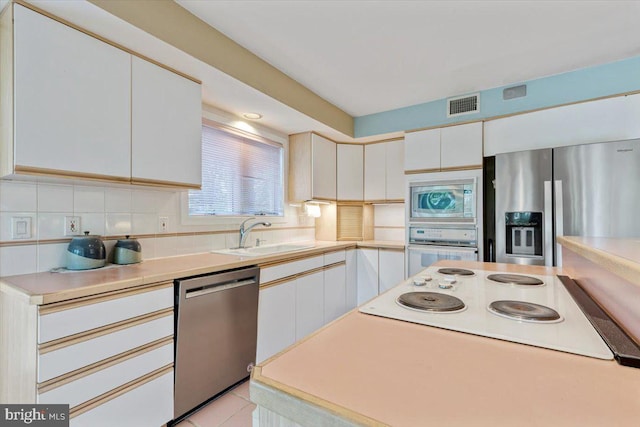 3 White Horse Ln, Spring City, PA 19475 - kitchen featuring stainless steel appliances, a sink, white cabinetry, and backsplash