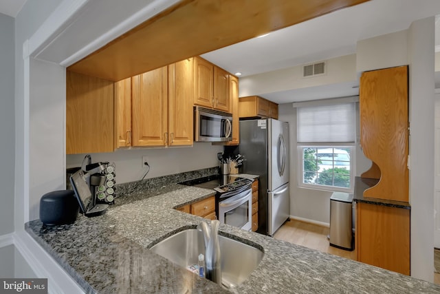 3331 Lakeside View Dr Unit 6-8, Falls Church, VA 22041 - kitchen featuring stainless steel appliances, dark stone countertops, light wood-style floors, and a sink