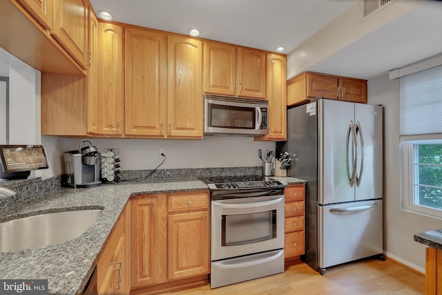 3331 Lakeside View Dr Unit 6-8, Falls Church, VA 22041 - kitchen featuring stainless steel appliances, light wood-type flooring, recessed lighting, light stone counters, and a sink