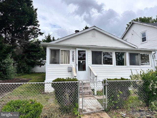 2233 N Dinwiddie St, Arlington, VA 22207 - bungalow-style home with a fenced front yard and a gate