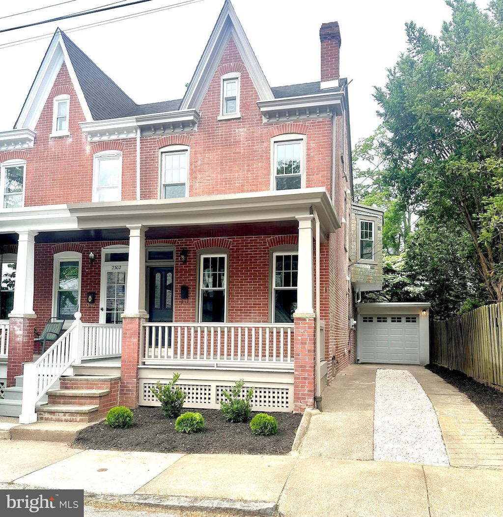 2304 W 19th St, Wilmington, DE 19806 - multi unit property featuring brick siding, concrete driveway, covered porch, and a garage