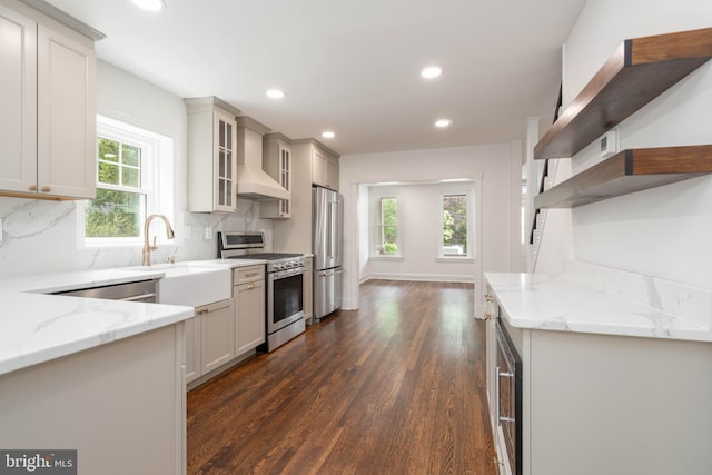 2304 W 19th St, Wilmington, DE 19806 - kitchen featuring stainless steel appliances, dark wood-style floors, light stone counters, a sink, and backsplash