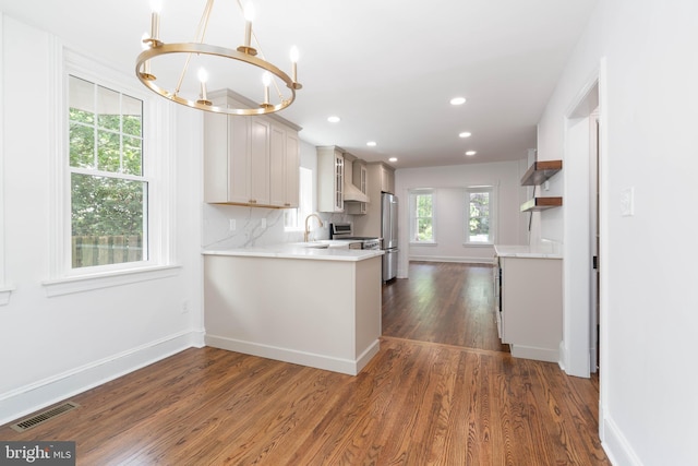 2304 W 19th St, Wilmington, DE 19806 - kitchen with appliances with stainless steel finishes, a chandelier, light countertops, dark wood-style floors, and recessed lighting