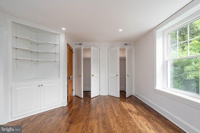 2304 W 19th St, Wilmington, DE 19806 - unfurnished bedroom with multiple windows, multiple closets, dark wood-style flooring, baseboards, and recessed lighting