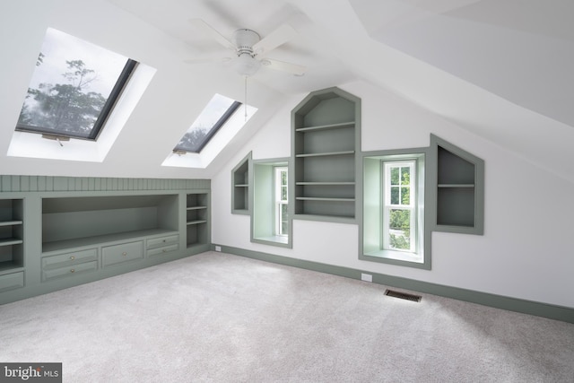 2304 W 19th St, Wilmington, DE 19806 - bonus room with built in shelves, a skylight, carpet flooring, a ceiling fan, and vaulted ceiling