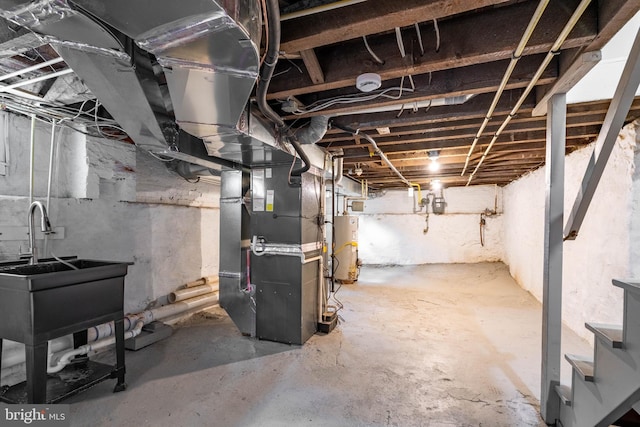 2304 W 19th St, Wilmington, DE 19806 - unfinished below grade area featuring water heater, heating unit, a sink, gas meter, and stairway