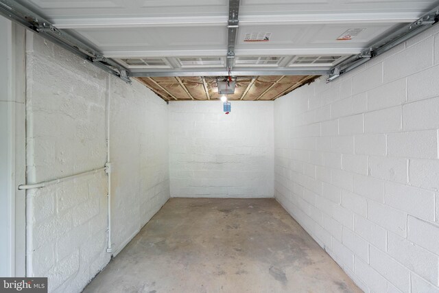2304 W 19th St, Wilmington, DE 19806 - garage featuring a garage door opener and concrete block wall