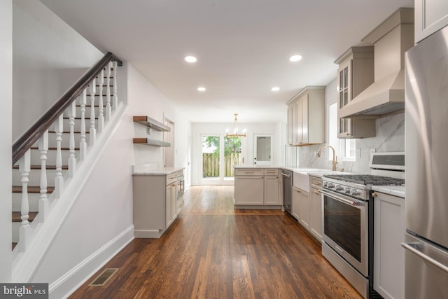 2304 W 19th St, Wilmington, DE 19806 - kitchen featuring stainless steel appliances, open shelves, dark wood-style floors, custom range hood, and recessed lighting