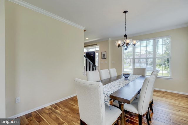 229 Lakshman Trl, Dover, DE 19904 - dining space featuring a chandelier, crown molding, baseboards, healthy amount of natural light, and wood finished floors