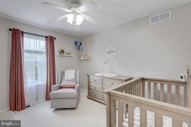 229 Lakshman Trl, Dover, DE 19904 - carpeted bedroom featuring a crib, a ceiling fan, and baseboards