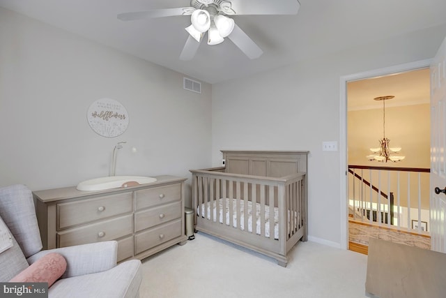 229 Lakshman Trl, Dover, DE 19904 - carpeted bedroom with a chandelier, a crib, and a ceiling fan