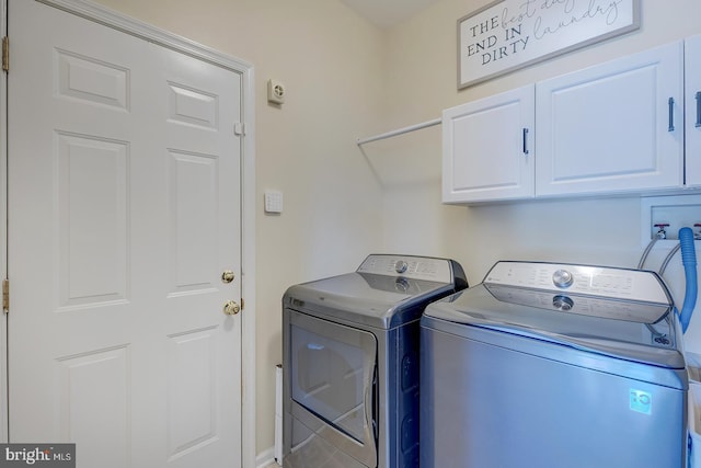 229 Lakshman Trl, Dover, DE 19904 - laundry area with cabinet space and washer and clothes dryer