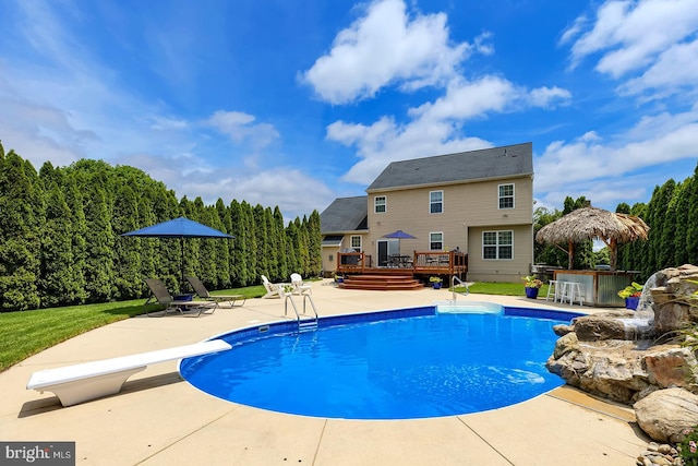 229 Lakshman Trl, Dover, DE 19904 - swimming pool with a wooden deck, a patio area, a diving board, and a lawn