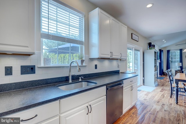229 Lakshman Trl, Dover, DE 19904 - kitchen featuring dishwasher, a sink, light wood-style floors, white cabinets, and tasteful backsplash
