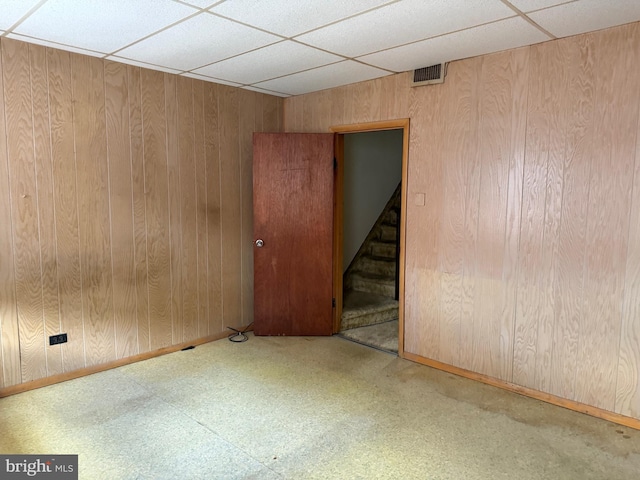 914 Fernon St, Philadelphia, PA 19148 - spare room with a drop ceiling, tile patterned floors, wooden walls, baseboards, and stairs