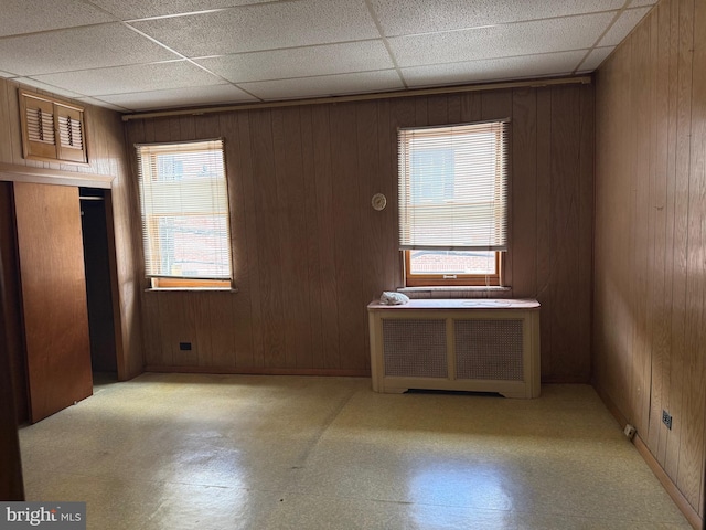 914 Fernon St, Philadelphia, PA 19148 - unfurnished room with radiator, wood walls, and a drop ceiling