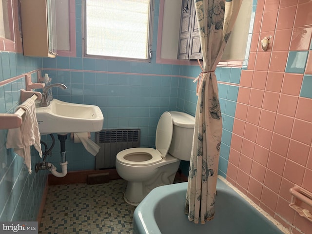 914 Fernon St, Philadelphia, PA 19148 - full bathroom with radiator heating unit, tile walls, toilet, and tile patterned floors