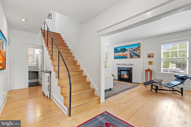 3700 Underwood St, Chevy Chase, MD 20815 - entryway featuring wood finished floors, a glass covered fireplace, stairway, and baseboards