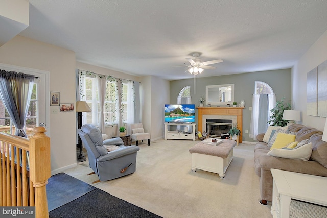 600 Small Reward Rd, Huntingtown, MD 20639 - living room with plenty of natural light, ceiling fan, baseboards, and a glass covered fireplace