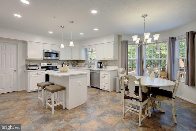 600 Small Reward Rd, Huntingtown, MD 20639 - kitchen with stainless steel appliances, a center island, a chandelier, white cabinets, and recessed lighting