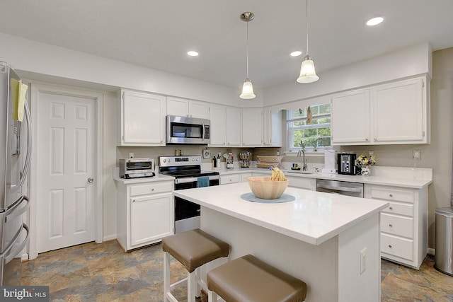 600 Small Reward Rd, Huntingtown, MD 20639 - kitchen with stainless steel appliances, white cabinets, stone finish floors, a kitchen island, and recessed lighting