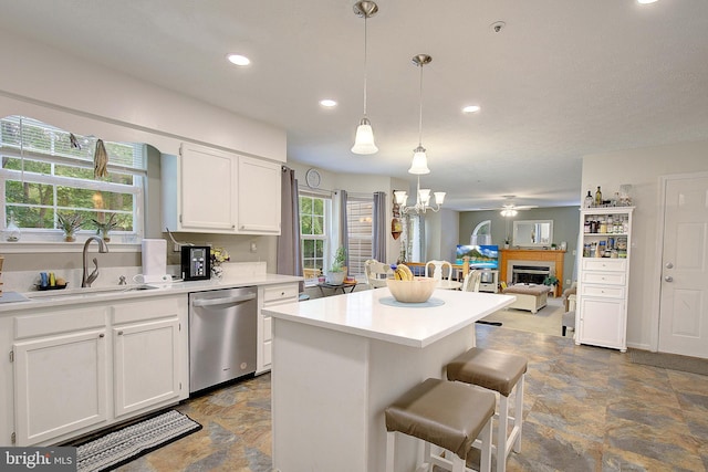 600 Small Reward Rd, Huntingtown, MD 20639 - kitchen featuring dishwasher, a sink, dark stone finish flooring, a chandelier, and a fireplace