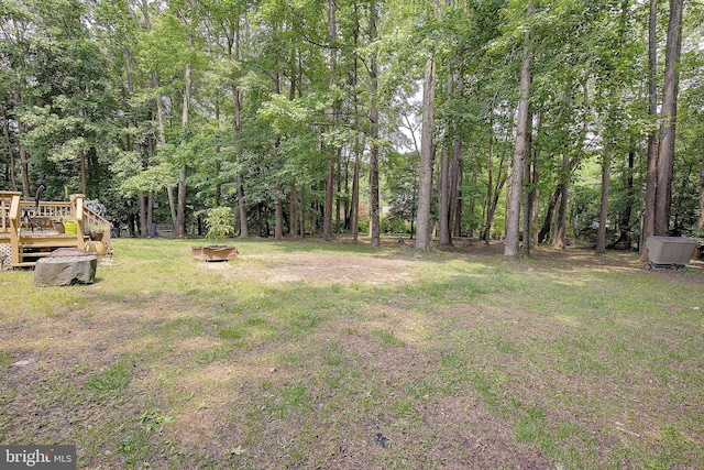 600 Small Reward Rd, Huntingtown, MD 20639 - view of grassy yard with a deck and an outdoor fire pit