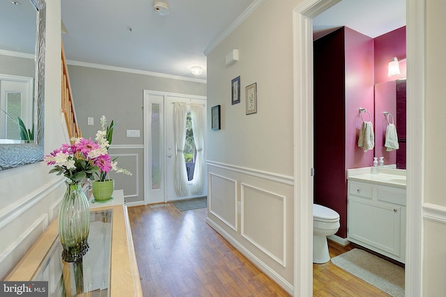 600 Small Reward Rd, Huntingtown, MD 20639 - entryway featuring a decorative wall, wood finished floors, crown molding, and a wainscoted wall