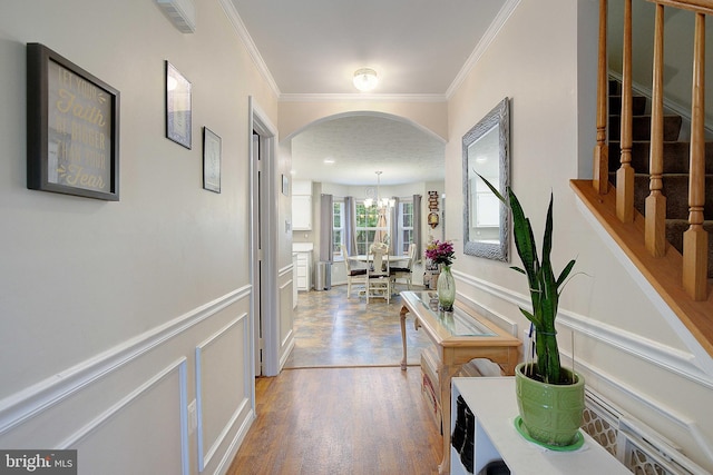 600 Small Reward Rd, Huntingtown, MD 20639 - hallway with a decorative wall, arched walkways, ornamental molding, stairs, and a wainscoted wall