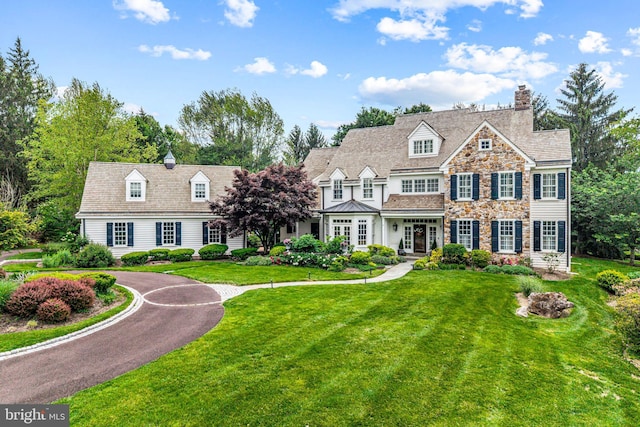1298 Farm Ln, Berwyn, PA 19312 - shingle-style home with stone siding, a front yard, a chimney, and french doors