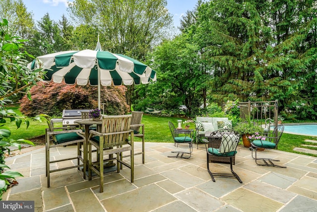 1298 Farm Ln, Berwyn, PA 19312 - view of patio featuring outdoor dining space, area for grilling, an outdoor pool, view of scattered trees, and an outdoor hangout area