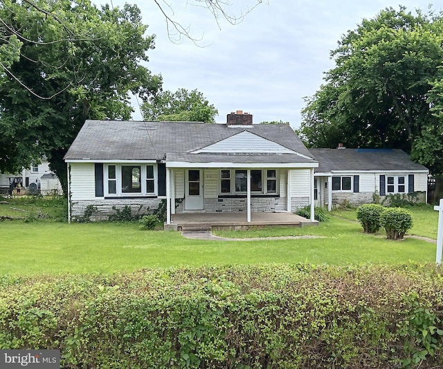 212 Coakley St, Fredericksburg, VA 22401 - view of front of home featuring a porch, a front yard, stone siding, and a chimney