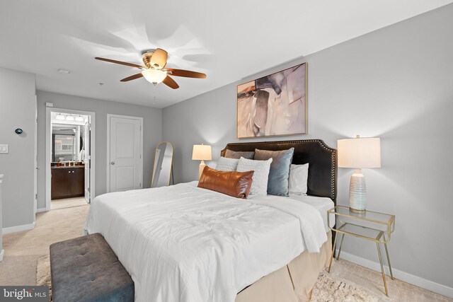 331 K St SE, Washington, DC 20003 - bedroom with baseboards, light colored carpet, connected bathroom, and ceiling fan