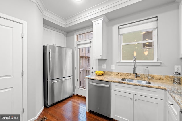 331 K St SE, Washington, DC 20003 - kitchen with stainless steel appliances, dark wood finished floors, a sink, white cabinets, and crown molding