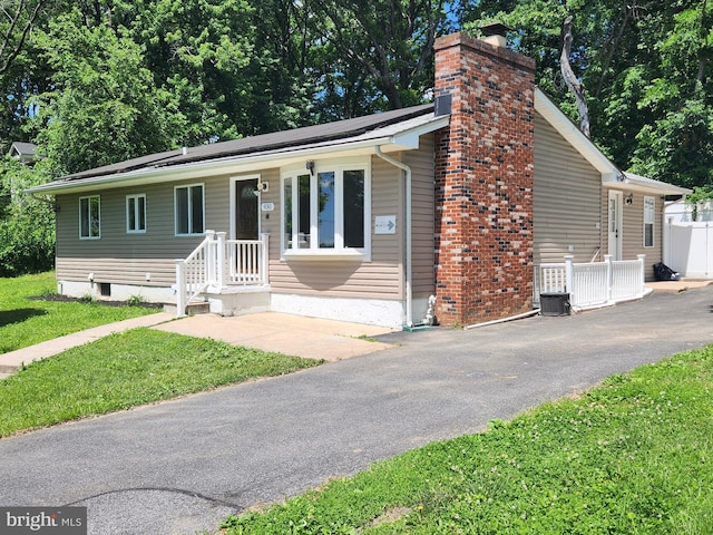 930 Chesaco Ave, Baltimore, MD 21237 - view of front of house with a chimney and driveway