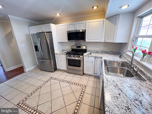 930 Chesaco Ave, Baltimore, MD 21237 - kitchen with appliances with stainless steel finishes, a sink, white cabinets, baseboards, and ornamental molding