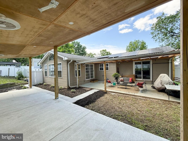 930 Chesaco Ave, Baltimore, MD 21237 - back of property featuring a patio, solar panels, an outdoor living space, and roof with shingles