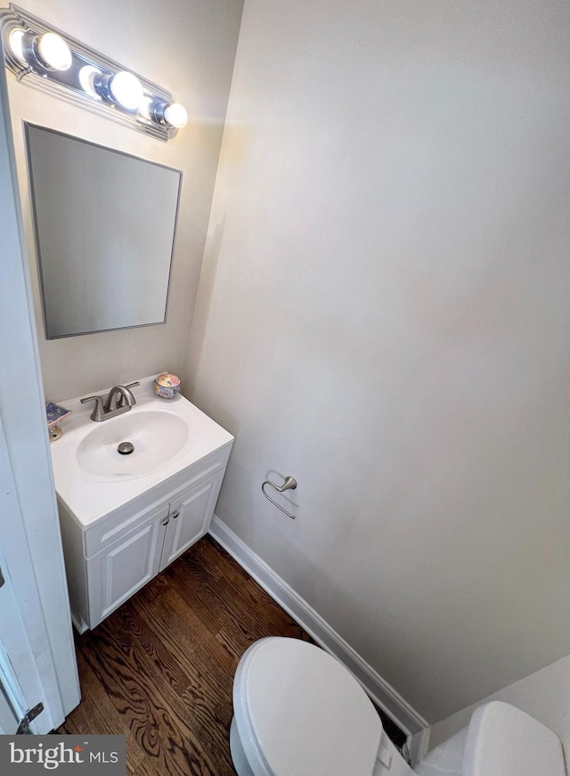 930 Chesaco Ave, Baltimore, MD 21237 - bathroom with toilet, wood finished floors, vanity, and baseboards