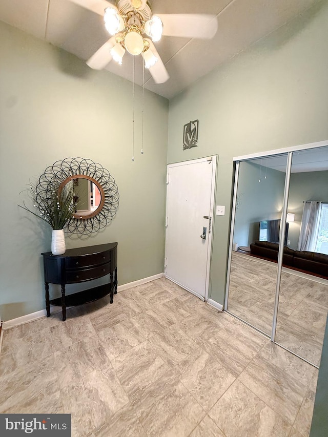 128 Roberts Ln Unit 100, Alexandria, VA 22314 - interior space with a towering ceiling, ceiling fan, and baseboards