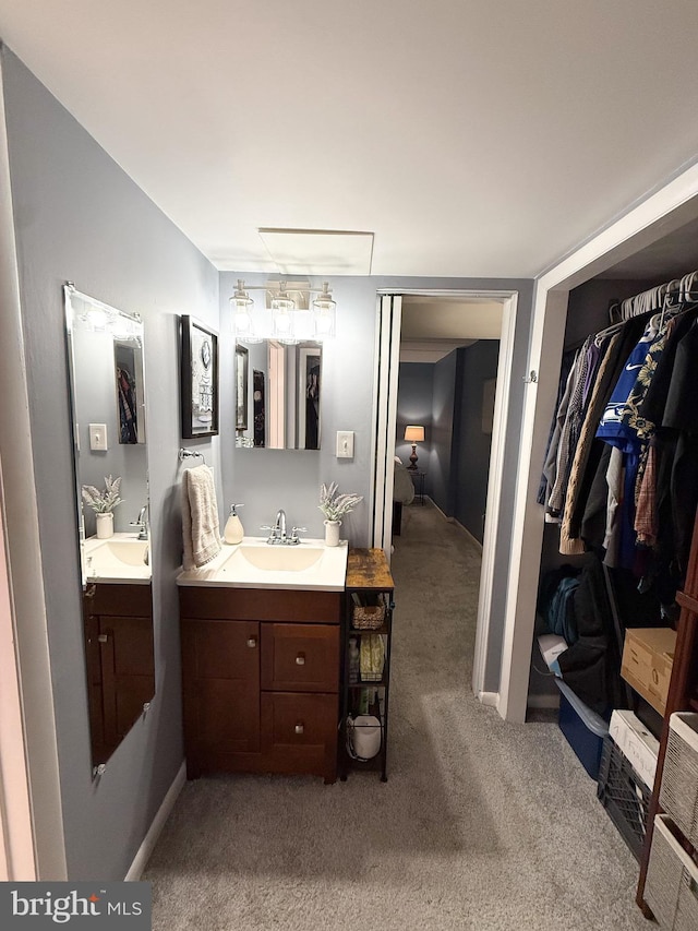128 Roberts Ln Unit 100, Alexandria, VA 22314 - bathroom featuring vanity, a spacious closet, and carpet