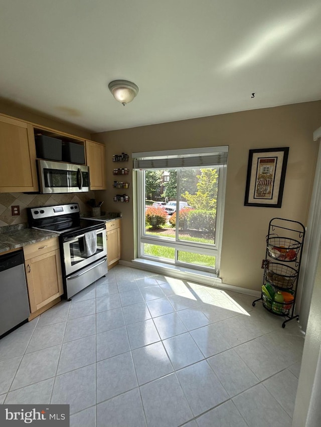 128 Roberts Ln Unit 100, Alexandria, VA 22314 - kitchen with stainless steel appliances, light brown cabinets, light tile patterned flooring, and tasteful backsplash