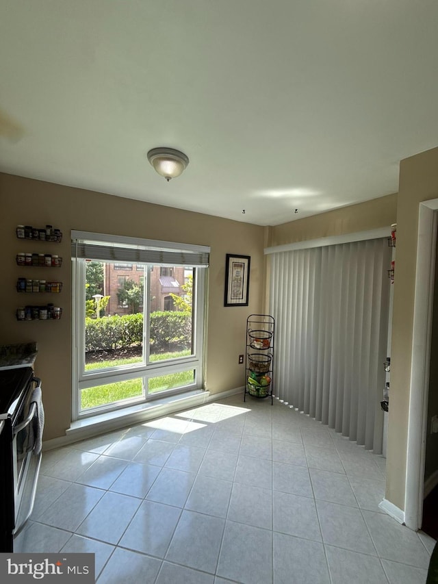 128 Roberts Ln Unit 100, Alexandria, VA 22314 - unfurnished living room with light tile patterned floors and baseboards