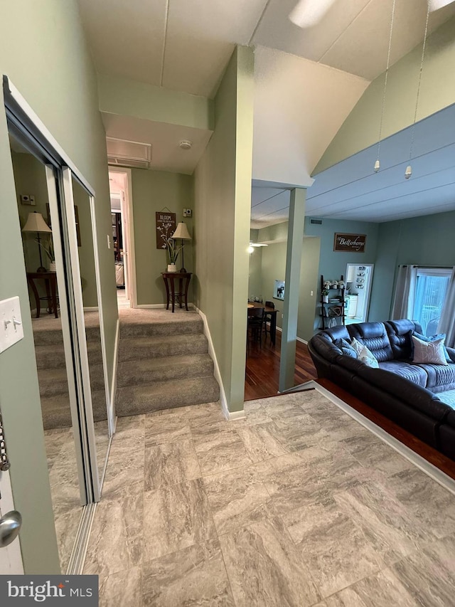 128 Roberts Ln Unit 100, Alexandria, VA 22314 - corridor featuring stairway, baseboards, and lofted ceiling