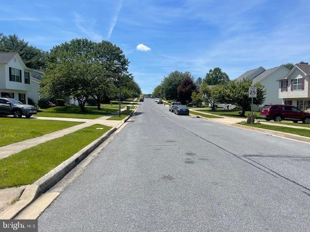 1151 Caton Rd, Hampstead, MD 21074 - view of asphalt street featuring sidewalks, a residential view, and curbs